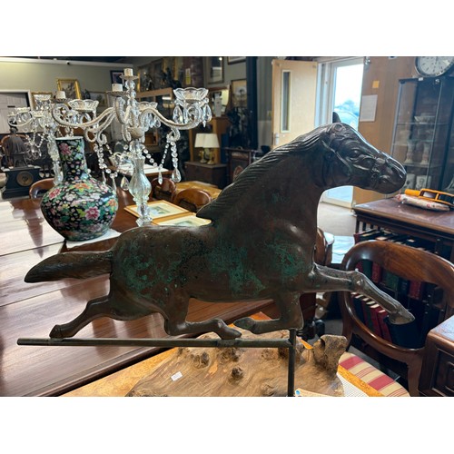 772 - A patinated bronze weather vane in the form of a horse on a driftwood base 58cm high

Good: In good ... 