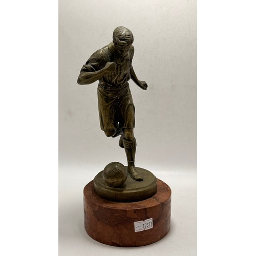 214 - A Collection of three football figurines of various medians. Two bronze,  and one resin