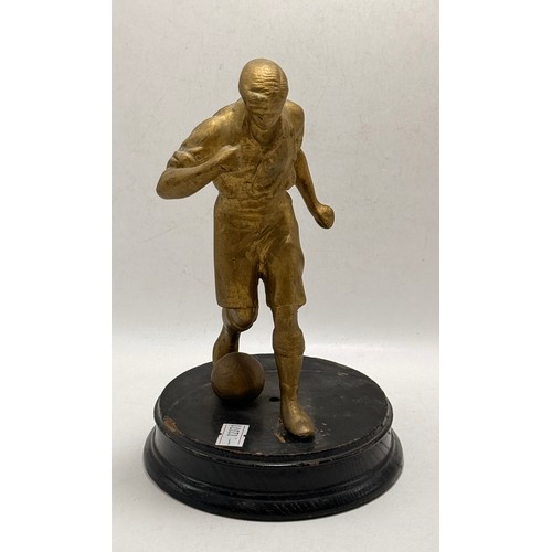 214 - A Collection of three football figurines of various medians. Two bronze,  and one resin