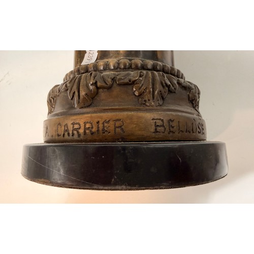 10 - A pair of bronze or spelter French candlesticks which are cherubs sitting on round bases