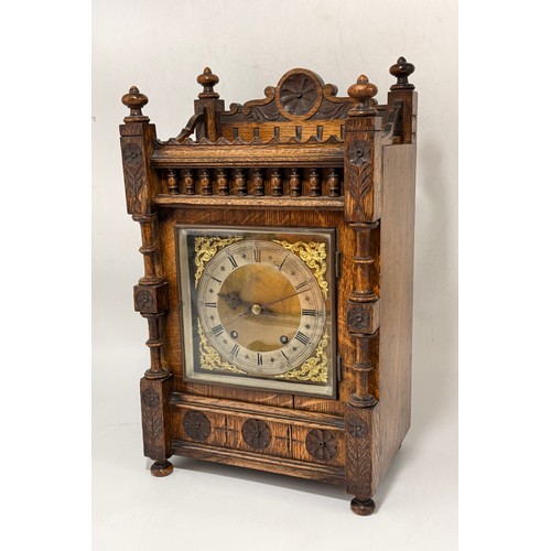 47 - Arts & Crafts Mahogany Mantel Clock with a heavily carved case.  Silver chapter ring with Roman nume... 