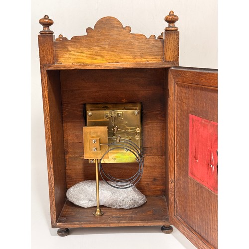 47 - Arts & Crafts Mahogany Mantel Clock with a heavily carved case.  Silver chapter ring with Roman nume... 