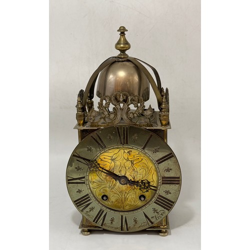 16 - An antique Brass Lantern Clock with French movement replacement, dial inscribed John Wainwright, Wel... 