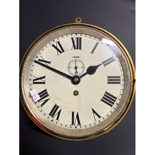 19 - A ships brass wall clock ( made in England ) 25cm diameter with key