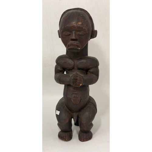 29 - Two wooden sculptures - A carved Thuya burl wood monk style plus carved African power figure