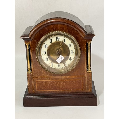 37 - Two Clocks.  An Antique ebonized Victorian mantel clock with pillar supports By Ansonia clock compan... 