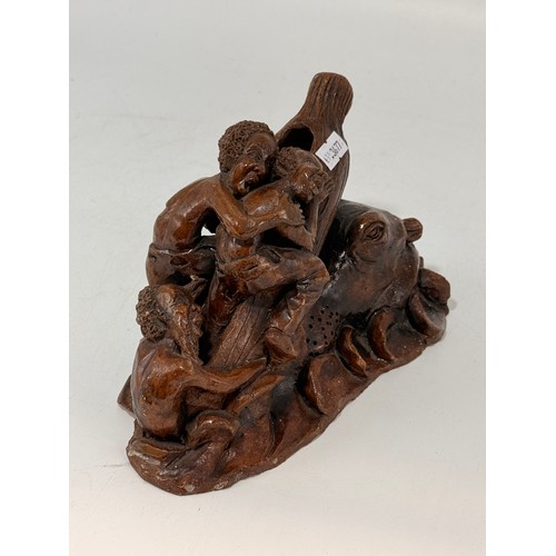 28 - Hand carved wooden sculpture.  Depicting a scene of figures trying to board a log/raft to escape a c... 