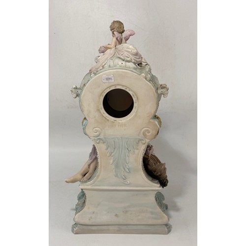 32 - Continental porcelain mantel clock.  Rococo style gilded details and figural sculptures.  Mercedes c... 