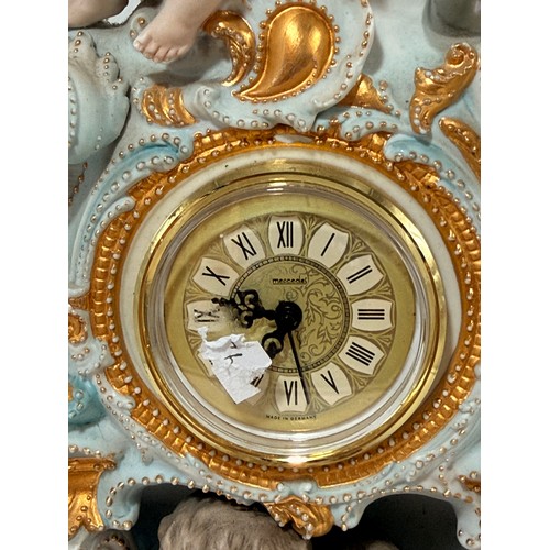 32 - Continental porcelain mantel clock.  Rococo style gilded details and figural sculptures.  Mercedes c... 