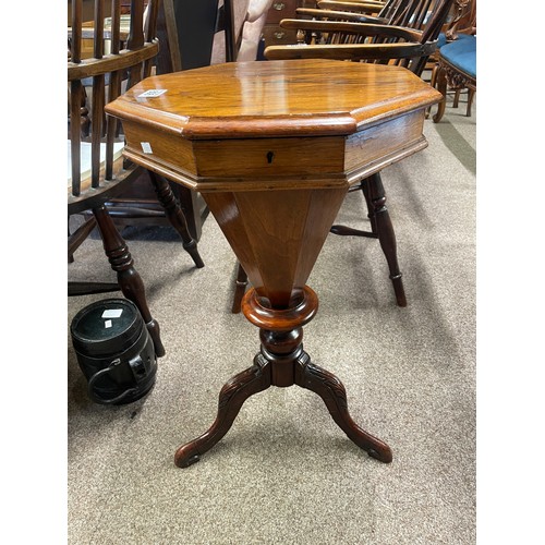 606 - An antique rosewood hexagonal work table with fitted contents on carved legs, 67cm high, 41.5cm wide