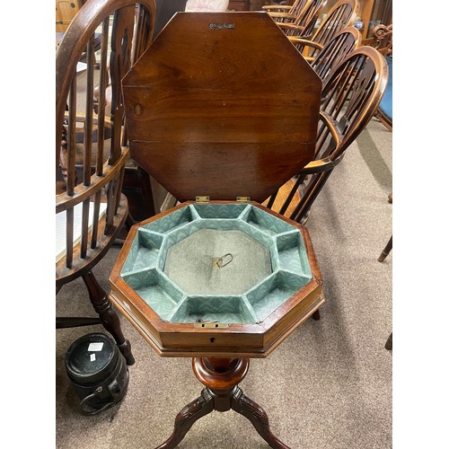 606 - An antique rosewood hexagonal work table with fitted contents on carved legs, 67cm high, 41.5cm wide