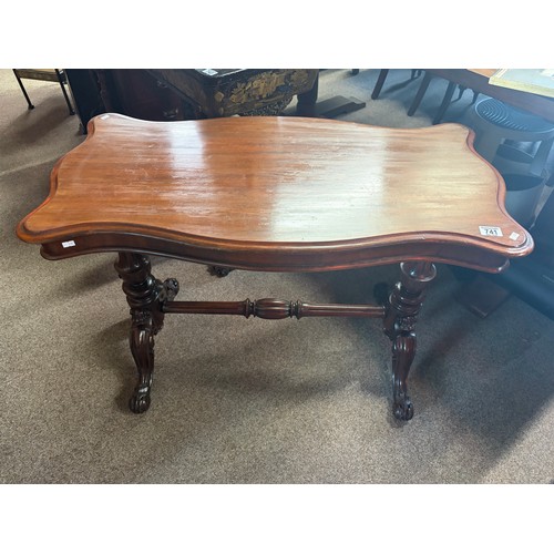 613 - An antique mahogany hall table of serpentine outline on heavily carved supports 96cm wide x 50cm dee... 