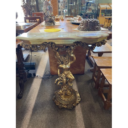 612 - A gilt and onyx console table, the support moulded as a cherub, 82.5cm, 30cm deep, 81cm high