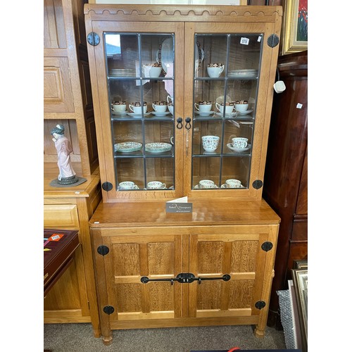 570 - A Robert 'Mouseman' Thompson display cabinet, a glazed bookcase above latched cupboard, with pewter ... 