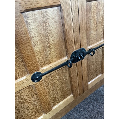 570 - A Robert 'Mouseman' Thompson display cabinet, a glazed bookcase above latched cupboard, with pewter ... 