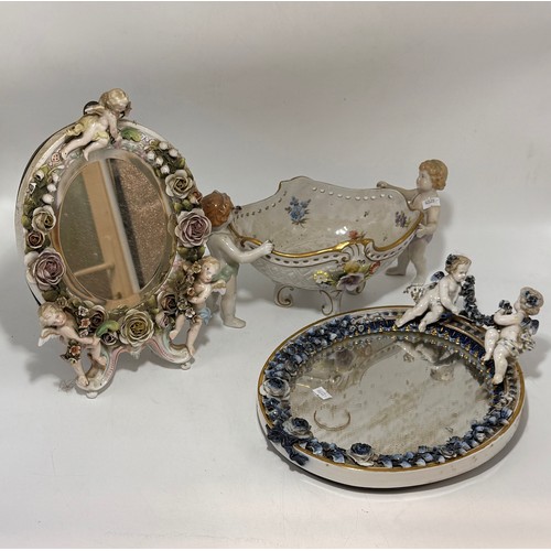 311 - Three items comprising a Von Schierholz porcelain centrepiece with two putti elaborately decorated w... 