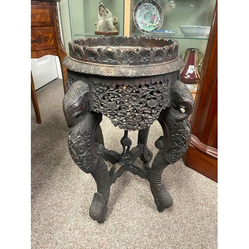 594 - A 19th century Anglo-Indian jardiniere stand, the heavily carved legs formed as elephants 51cm high,... 
