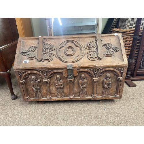 588 - A 15th century style chest, iron bound with carved figures to the exterior, 80cm wide, 45cm high