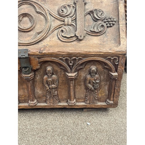 588 - A 15th century style chest, iron bound with carved figures to the exterior, 80cm wide, 45cm high