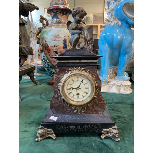 643 - A slate gilt mounted mantel clock, surmounted with a figure of Eros, 37cm high