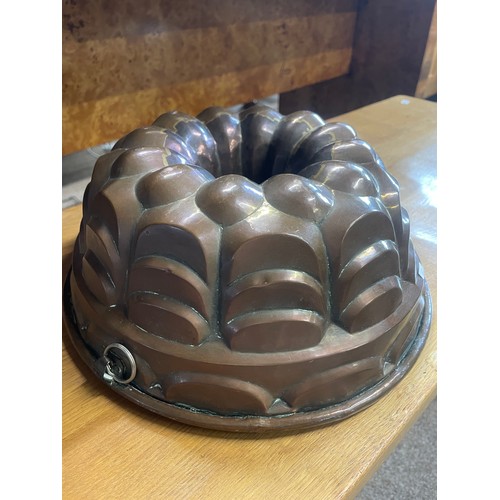 653 - An antique copper jelly mould, 30cm wide, 12cm high