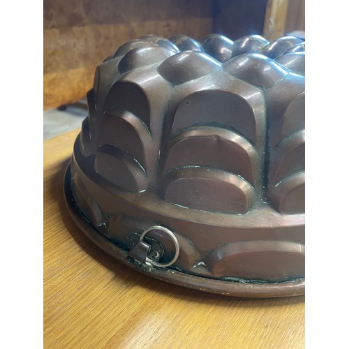 653 - An antique copper jelly mould, 30cm wide, 12cm high