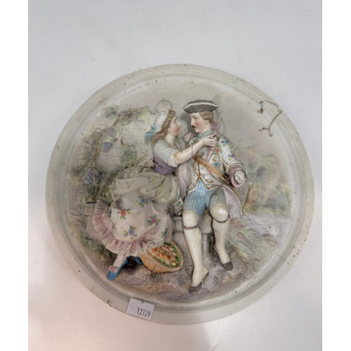 320 - Three bisque porcelain wall plaques featuring high-relief scenes of courting couples.  D 25 cm.
