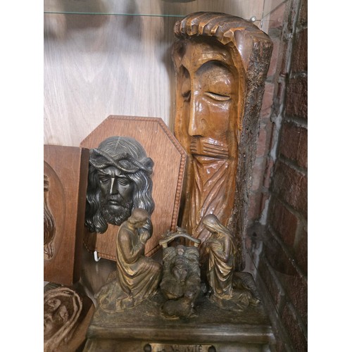56 - A Collection of Religious wall plaques and iconography in wood, brass and bronze.