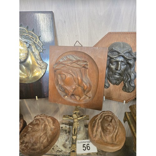 56 - A Collection of Religious wall plaques and iconography in wood, brass and bronze.