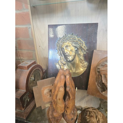 56 - A Collection of Religious wall plaques and iconography in wood, brass and bronze.