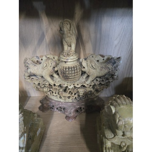 57 - six carved soapstone figures including an incense burner, buddha, foo dogs etc