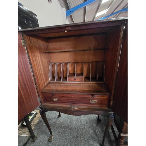 805 - A vintage Queen Anne style burr walnut cabinet raised on carved cabriole legs joined by a shaped apr... 