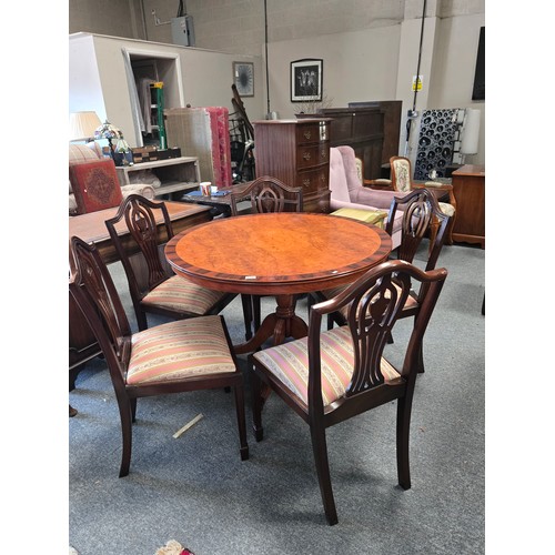 810 - A Modern Regency Style veneered walnut and mahogany round dining table with four shield back upholst... 