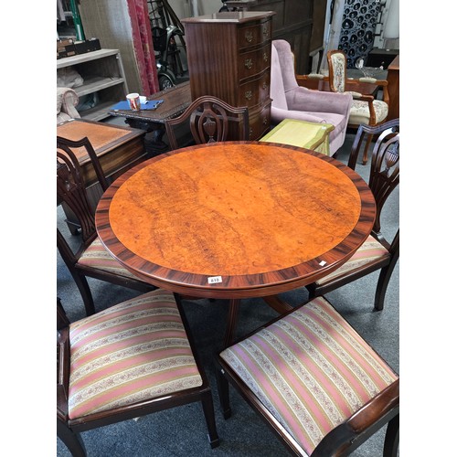 810 - A Modern Regency Style veneered walnut and mahogany round dining table with four shield back upholst... 