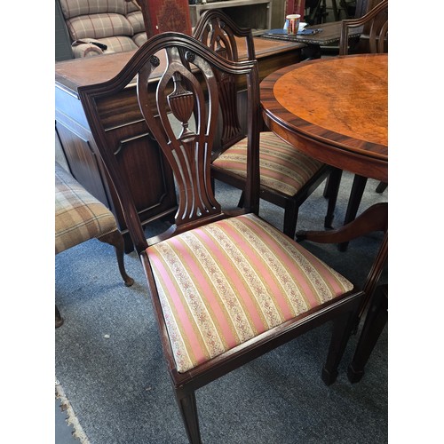 810 - A Modern Regency Style veneered walnut and mahogany round dining table with four shield back upholst... 