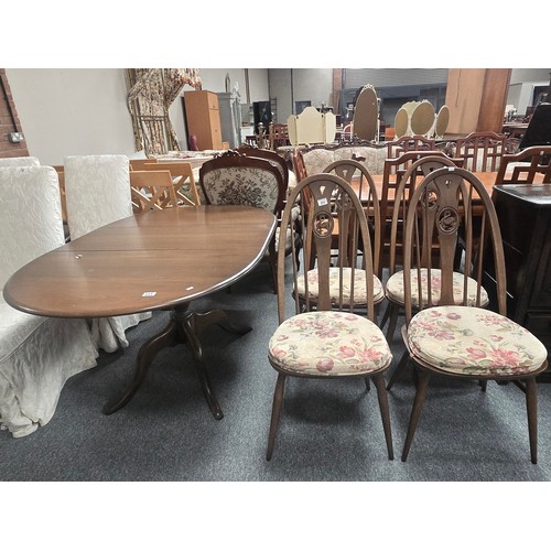 855 - A Vintage Ercol dark wood extendable Dining table and four Quaker swan chairs