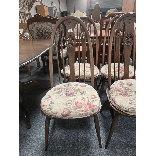 855 - A Vintage Ercol dark wood extendable Dining table and four Quaker swan chairs