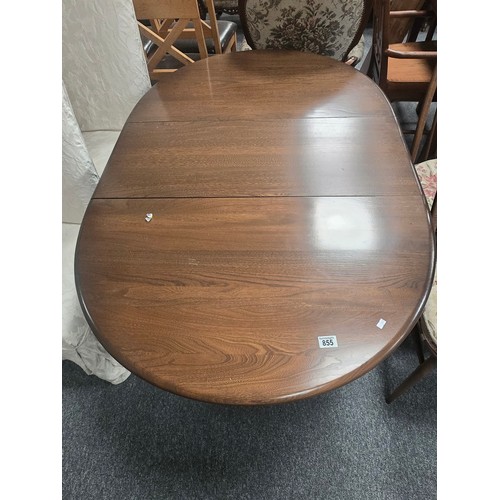 855 - A Vintage Ercol dark wood extendable Dining table and four Quaker swan chairs