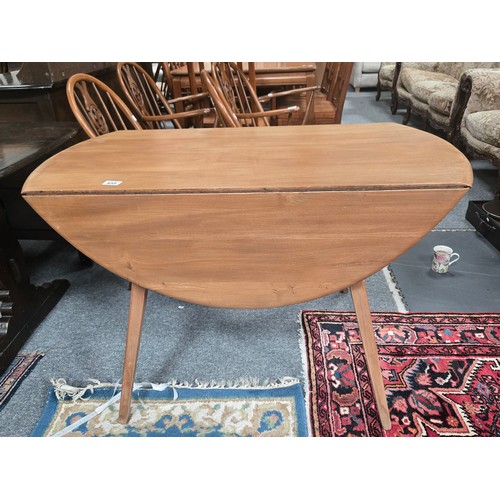 859 - A blonde Ercol mid-century 'Windsor' drop-leaf extending dining table, designed by Lucian Ercolani f... 