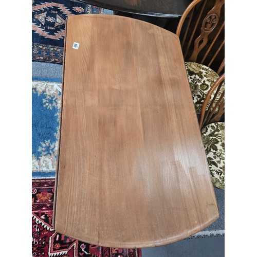 859 - A blonde Ercol mid-century 'Windsor' drop-leaf extending dining table, designed by Lucian Ercolani f... 