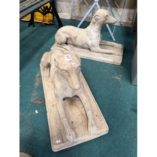 967 - A pair of composite stone dog sculptures, each modelled as a recumbent hound on a rectangular base. ... 