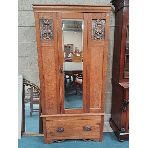 1015 - Arts and Crafts oak wardrobe with a single mirrored door and copper panels to either side.  One deep... 