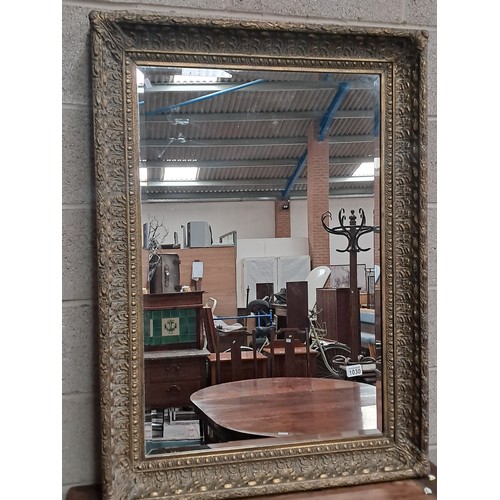 1030 - Large bevelled wall mirror with shabby chic ornate decorative surround 110cm x 79cm
