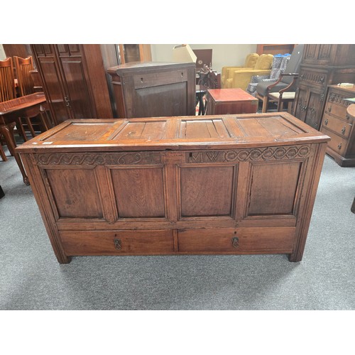 916 - An early English Oak panelled coffer with carved lunette frieze and 1697 and initials MW carved to f... 