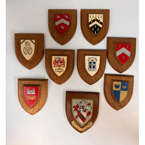 304 - A collection of nine wooden armorial shield plaques, including 'Exalted Order of the Extended Neck';... 