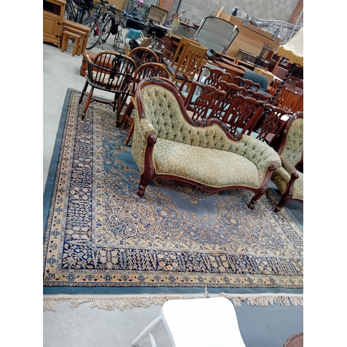 1019 - A large wool rug in blues, cream and gold with floral decorations. 4.2m x 2.8m