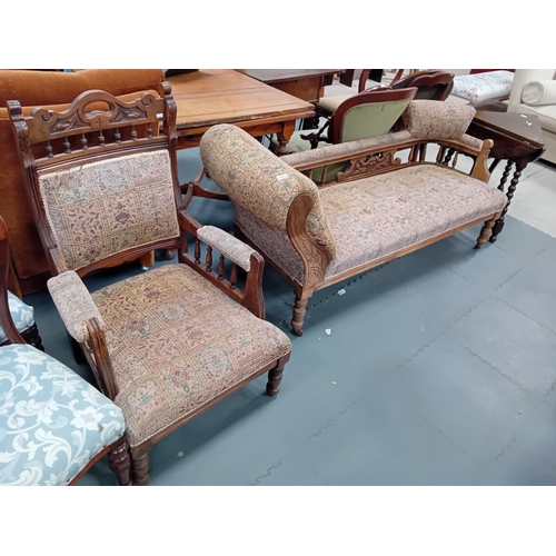 1078 - A Victorian oak chaise longue and matching arm chair.