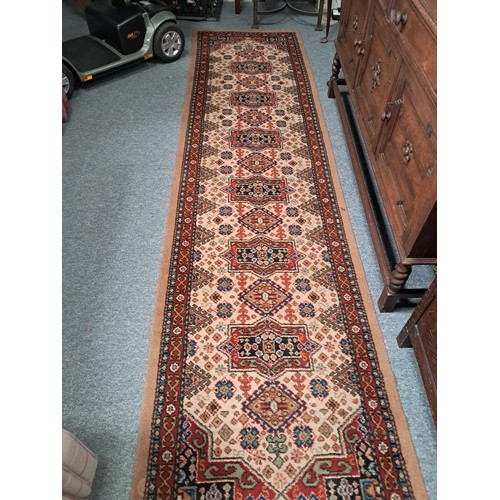 929A - Hand crafted wool runner with traditional geometric pattern of reds, blues and cream within decorati... 