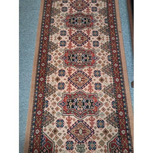 929A - Hand crafted wool runner with traditional geometric pattern of reds, blues and cream within decorati... 