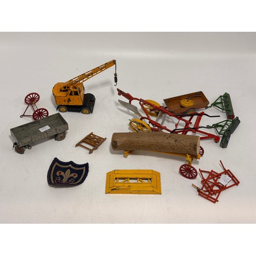 332 - A collection of toy vehicles and figures including Dinky 321 'Massey-Harris Manure Spreader' 27c, in... 